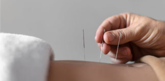 Close Up Hand Holding Acupuncture Needle (1)