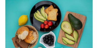 Top View Fresh Avocados Wood Kitchen Board With Avocado Slices Tomatoes Black Plate With Bucket Breads Blue